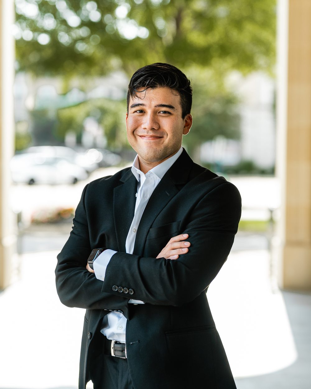 Alejandro Franco, founder of Franco & Co., standing with arms crossed outside an office building